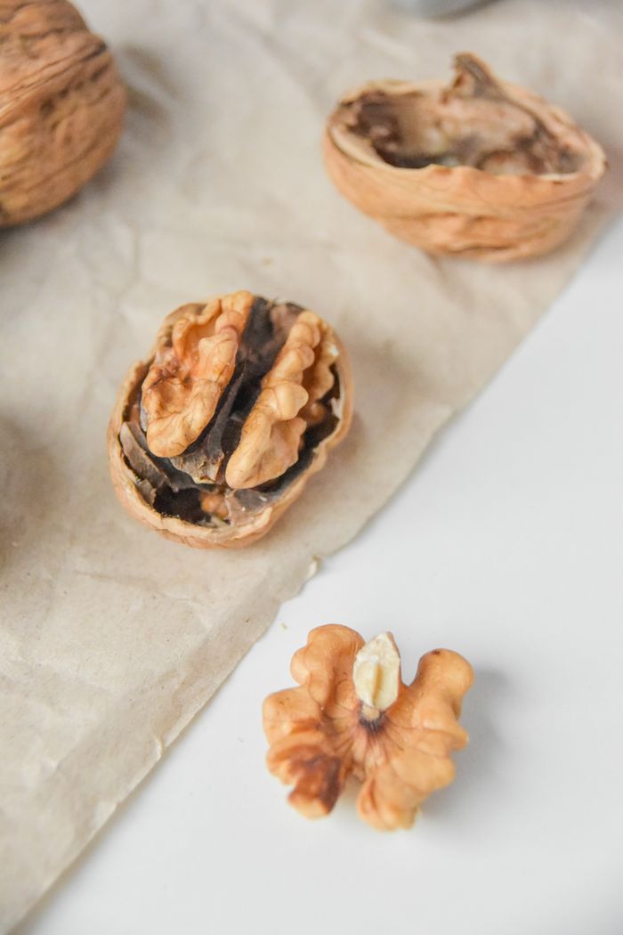 services-03 High-quality close-up of walnuts on parchment paper, highlighting texture and details.